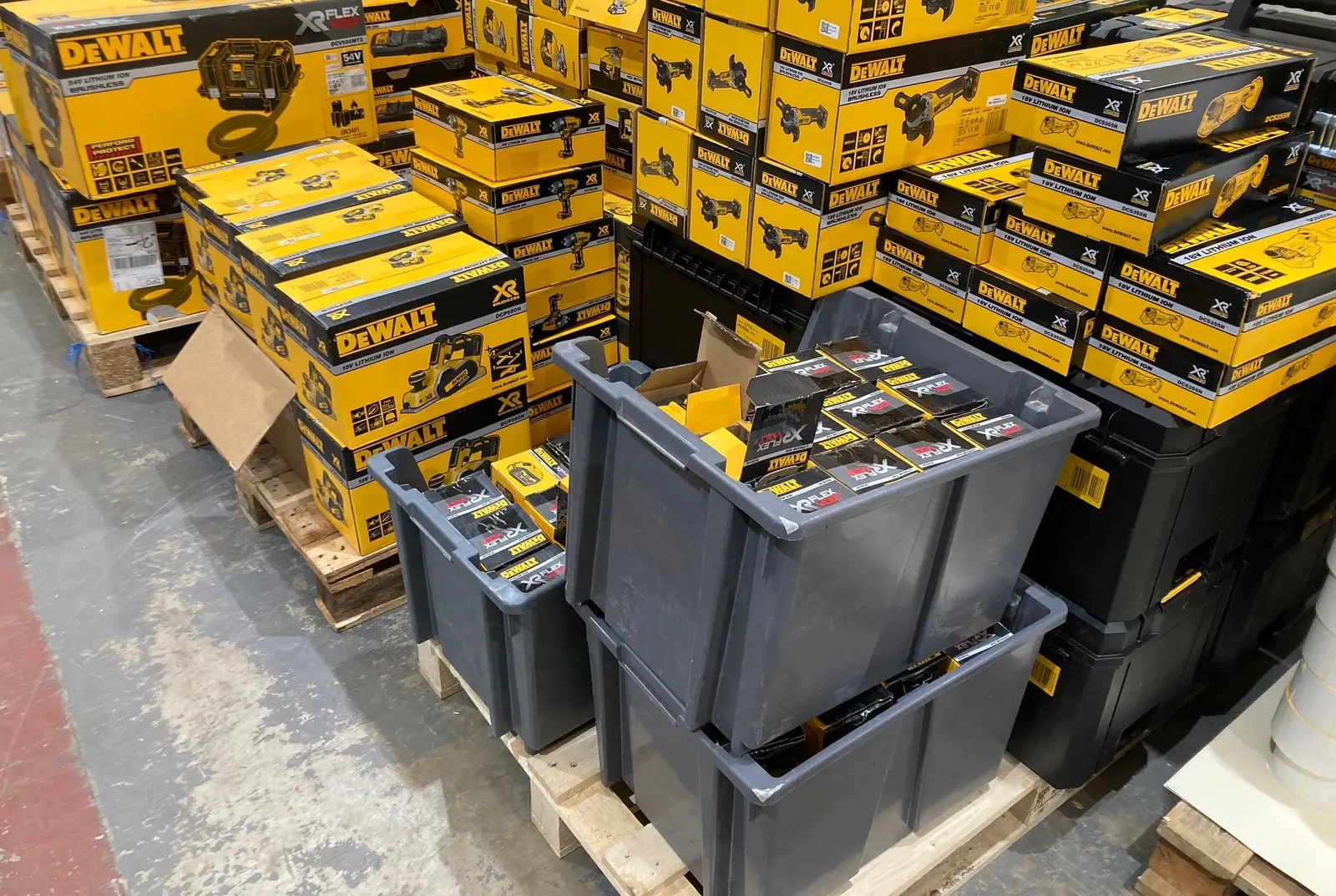 Pallets of boxed power tools and crates of batteries waiting to be marked